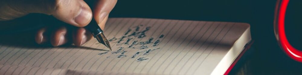 writes with a pen on a piece of paper